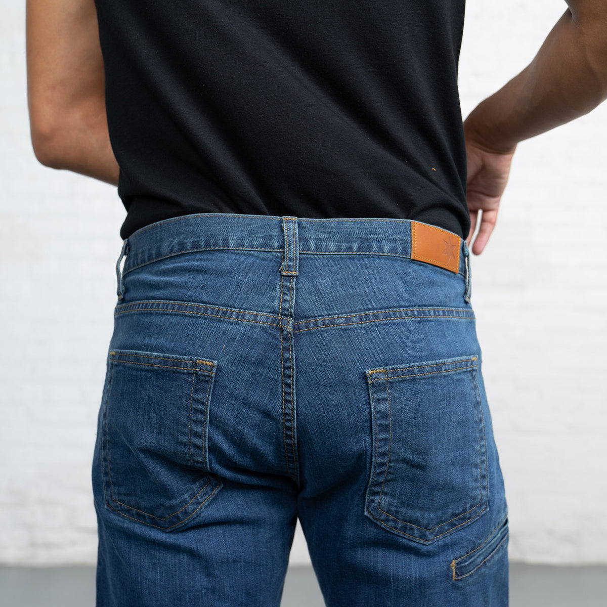 Close-up of the medium wash triblend stretch denim fabric and stitching