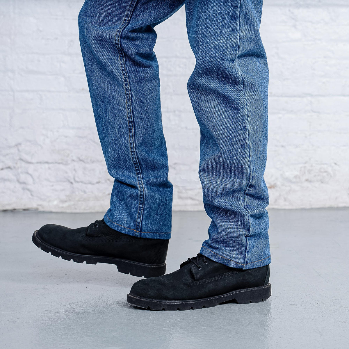 Cuff and leg opening detail of tapered stone wash jeans