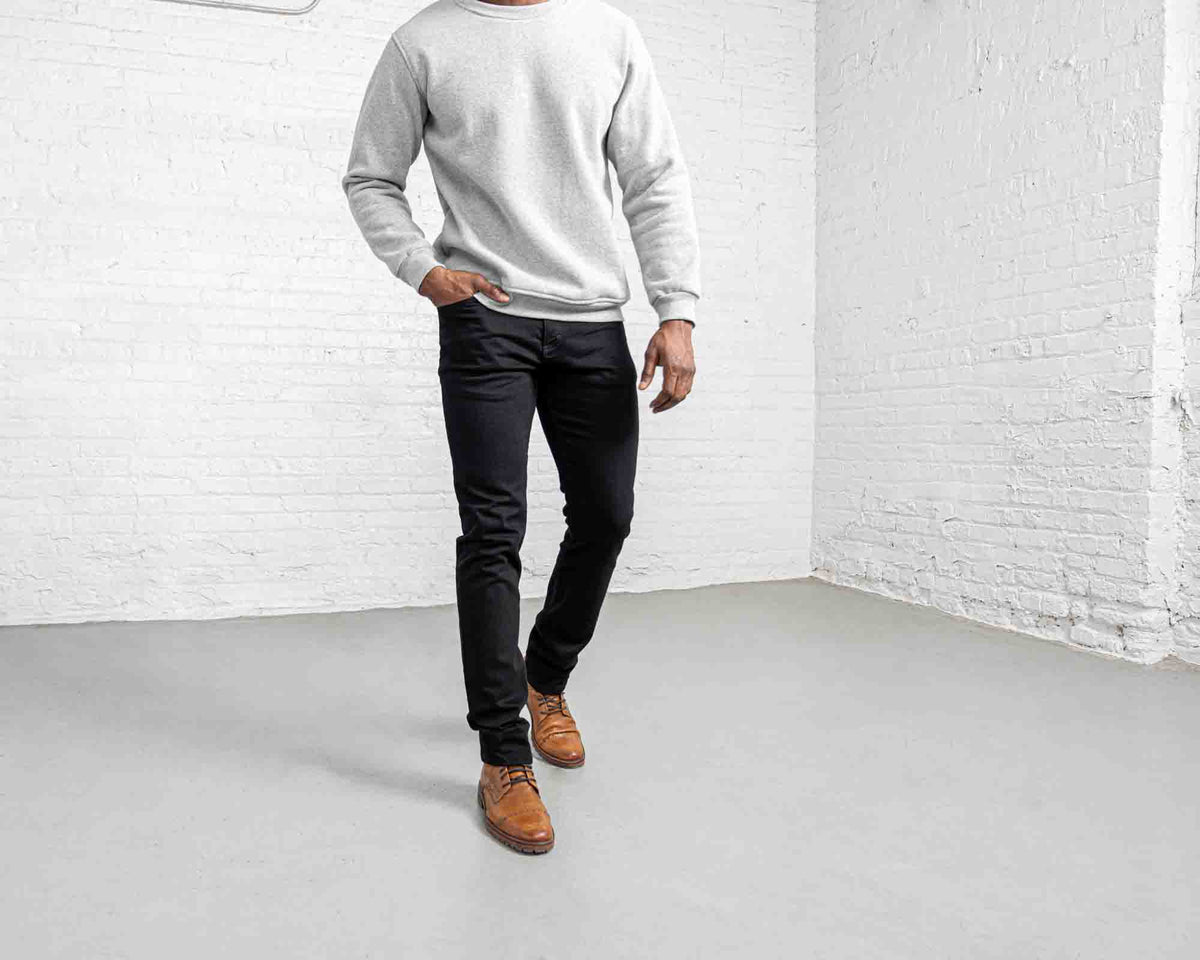 Man wearing black Tailored Fit jeans, full-length front view