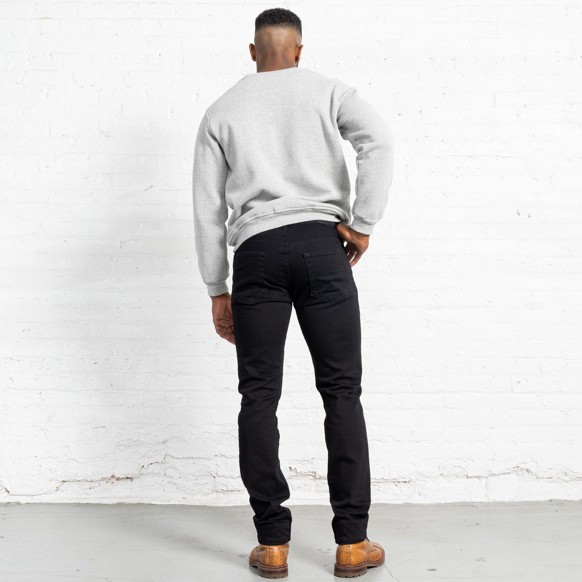 Front pocket and gold leaf button detail on black Tailored Fit jeans