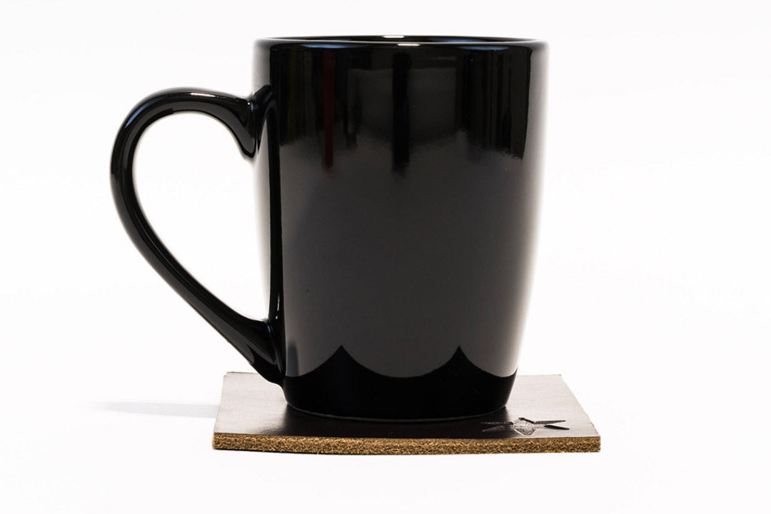 Single leather coaster shown flat from above, showing grain and natural color variation.